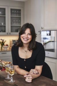 Porträttbild på Sveriges Mästerkock Tess Medina klädd i svart vid en köksö.
